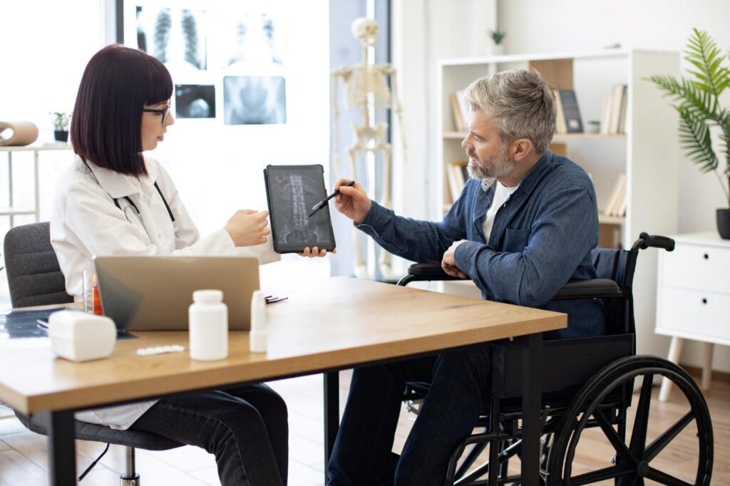 A person in a wheelchair holding a tablet